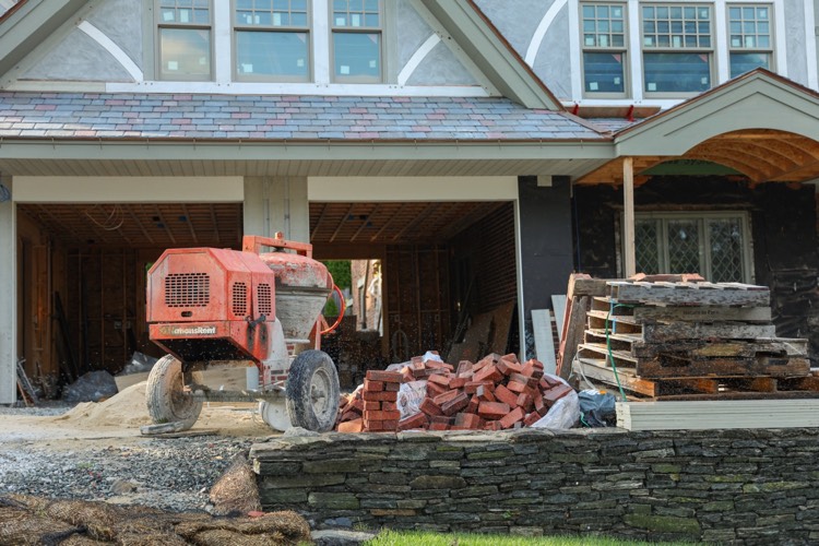 brick mortar mixer with pile of pallets