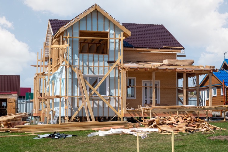 new home exterior application with scrap wood junk pile